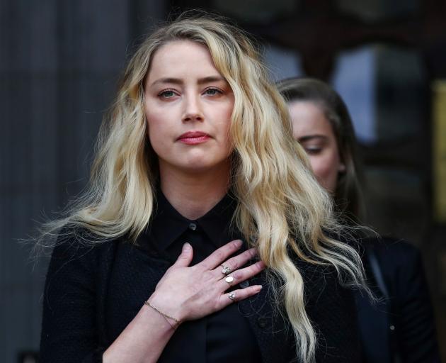 Amber Heard speaks to reporters outside court on Tuesday. Photo: Reuters 