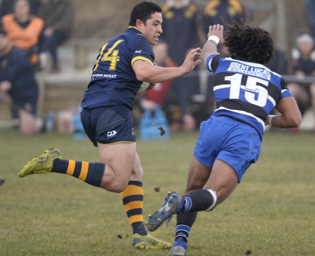 Dunedin wing Freedom Vahaakolo gets past Kaikorai fullback Roman Blackman on his way to scoring a...