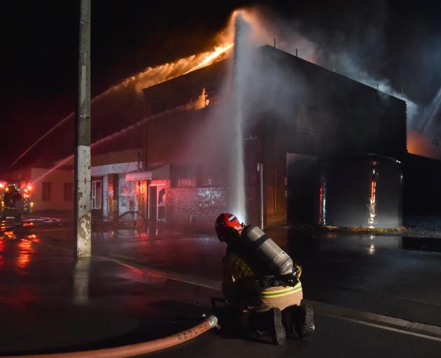 Firefighters tackle a blaze at the old Wolfenden and Russell building in South Dunedin on...