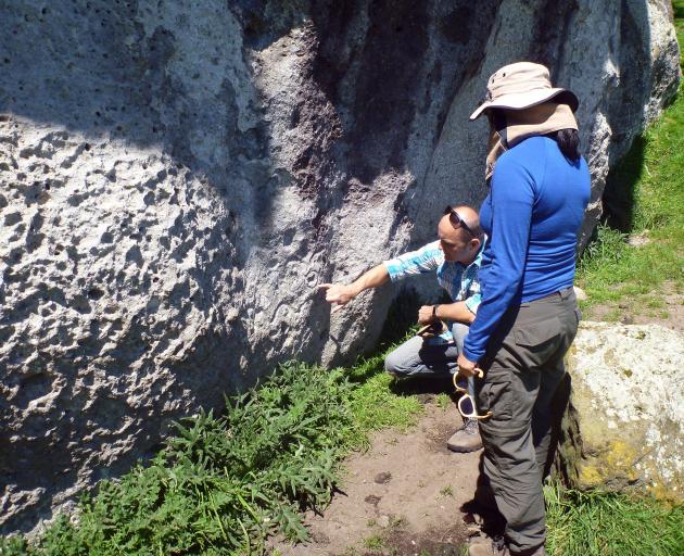 Otago Museum’s Maori curator Gerard O’Regan points to rock art in a cliff in the central North...