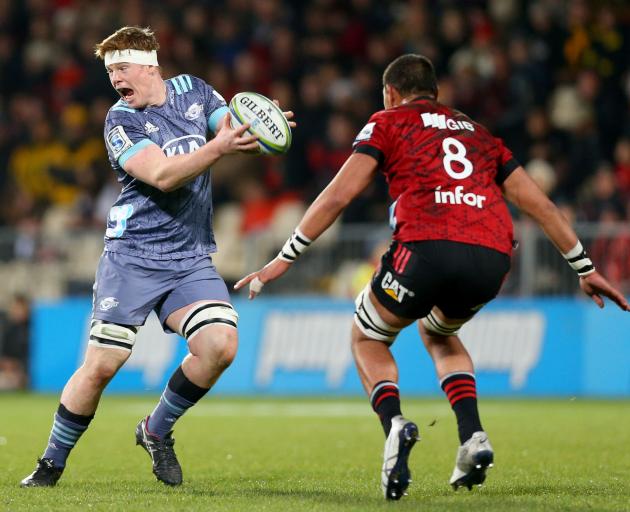 Hurricanes lock James Blackwell looks to sidestep Whetu Douglas of the Crusaders during a...