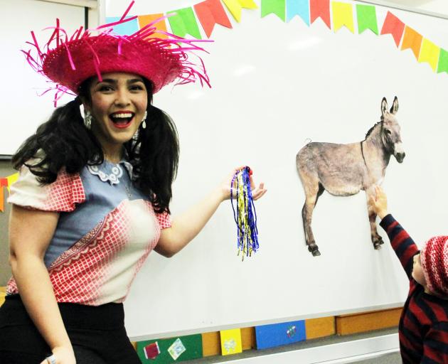 Brazilian Rafaella Melo shows how to play "put the tail on the donkey" at the Brazilian party...