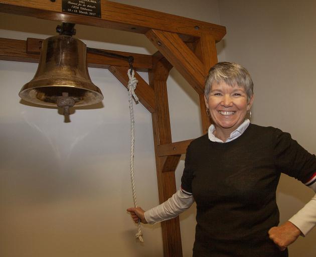 Bernadette May with the school's restored bell from 1931. Photo: Geoff Sloan