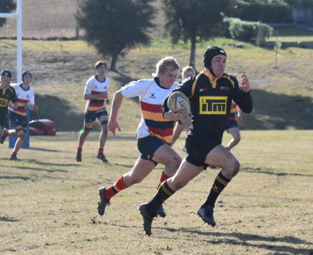 Kamryn Reddy of Mt Aspiring College on his way to the try line after intercepting a pass against...