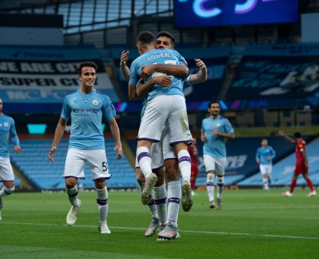 Phil Foden of Manchester City celebrates with his team mates after scoring this morning. Photo:...