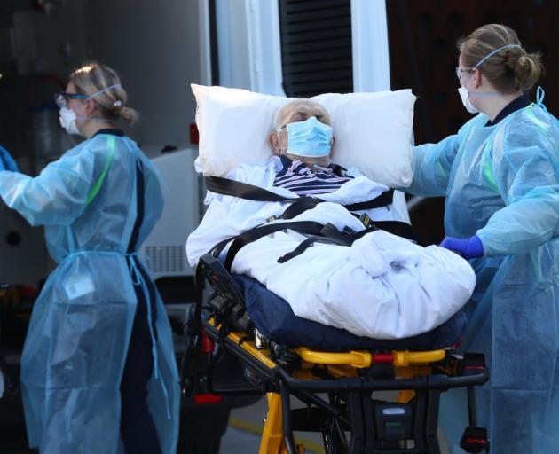An aged care resident is relocated in Melbourne yesterday. Photo: Getty Images