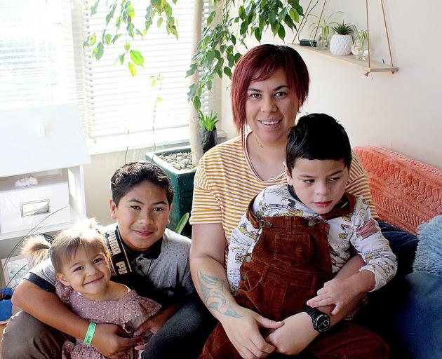 Danni Rasmussen holds Andre, 4, with Avie Avana, 2, and Alize, 11. They hope to soon embark on a...