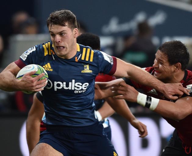 Highlanders flanker Dillon Hunt brushes off the tackle of Crusaders loose forward Whetu Douglas...