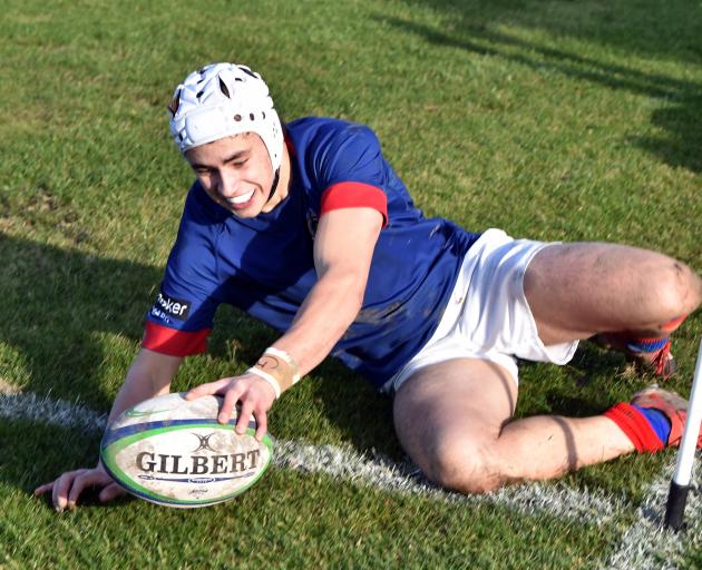 St Kevin’s wing Christian Bailee dots down for a try in the corner during his side’s win over...