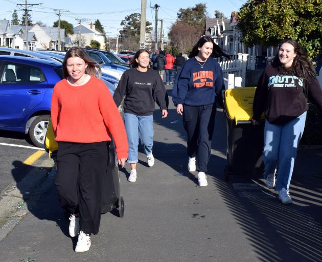 Wheeling recycling bins to a skip-diversion day in Castle St on Friday are (from left) Kate...