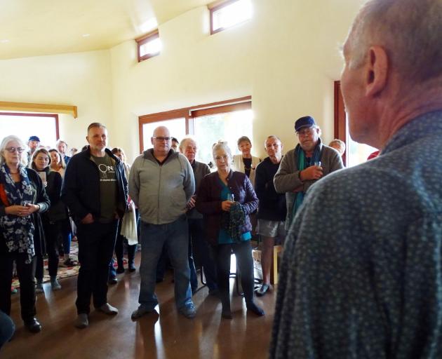 Maori Point Vineyard owner John Harris (right) calls to order the meeting of more than 50 locals...