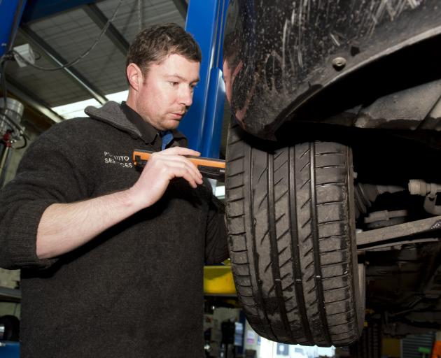 PD Auto Services director Nick Johnstone examines a client’s car during a warrant of fitness...
