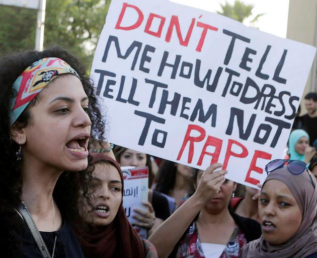 Women chant slogans as they gather to protest against sexual harassment in front of the opera house in Cairo. Photo: Reuters