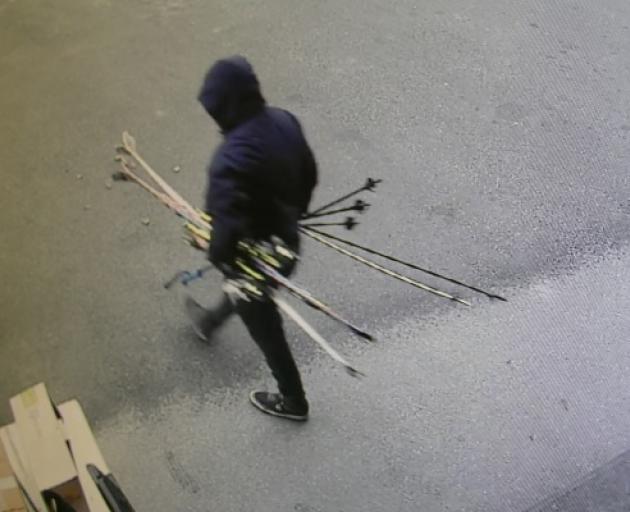 One of the people captured on CCTV helping himself to skis and poles from outside Hospice Shop Queenstown. Photo: Supplied