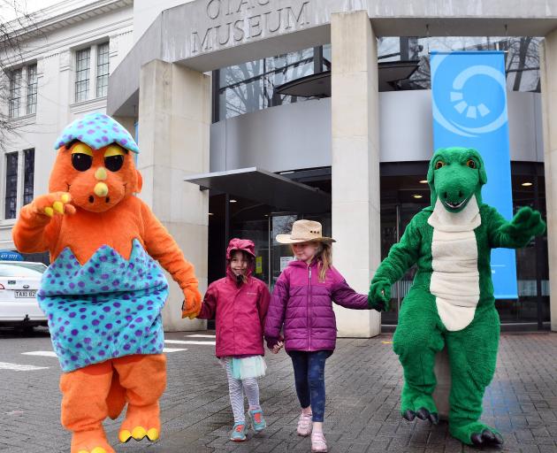 An orange dinosaur, aka Otago Museum head of exhibitions and creative services Craig Scott, and a...