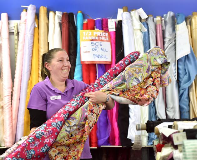 Lincraft sales assistant Erin Boock holds fabric, a hot commodity among shoppers at present....