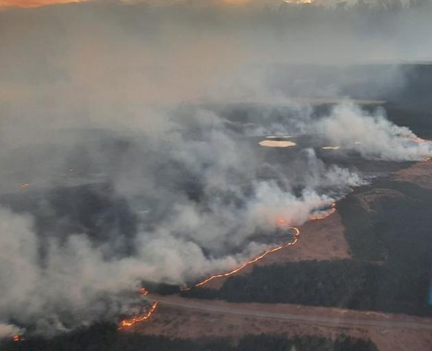 The fire near Twizel burns on both sides of the road yesterday. Photo: Aerial crews via Mackenzie District Council