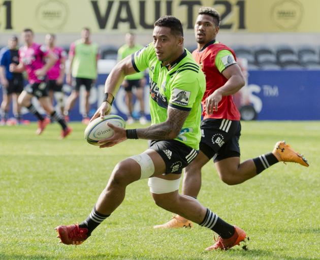 Highlanders loose forward Shannon Frizell looks to pass the ball while he is chased by reserve...