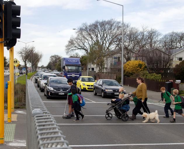 Pedestrians on SH76/Brougham St using a crossing near Addington School. Photo: Geoff Sloan