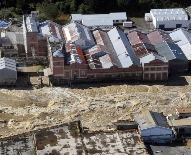 The flooded Mataura River rips past the former Mataura paper mill. Photo: Stephen Jaquiery