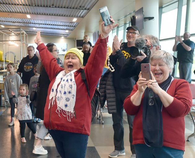 Otago Nuggets fans celebrate as the team walks into the Dunedin Airport terminal yesterday.
