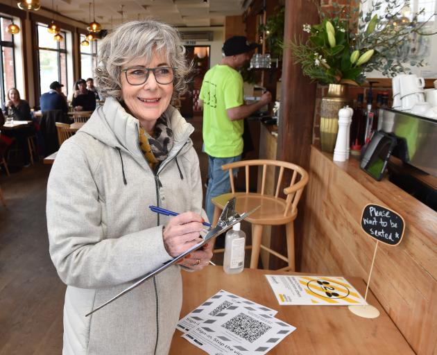 St Clair resident Melanie Garthwaite signs into the Esplanade Restaurant on Thursday afternoon....