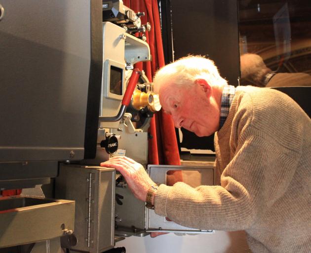 Regent Theatre projectionist Russell Campbell takes care of some maintenance on the theatre’s...