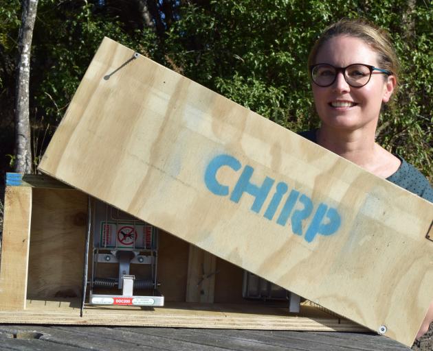 Chain Hills Restoration Project owner Rebecca Guest displays a stoat trap made by Otago...