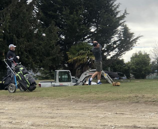 David Lee and Jamie Nesbitt play golf on the first nine at the Wanaka Golf Club, reduced to an...