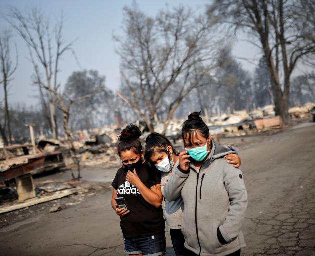 Sandra, Daniela, and Ester Reyes lost their trailer home after the wildfires destroyed a...