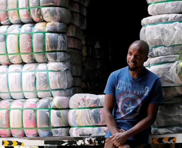 Salesman Anthony Kang'ethe with bales of imported second-hand clothes at the Gikomba market in...