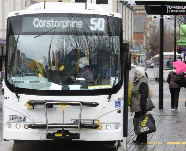 A bus driver explains the use of the new Bee Card to a passenger as another waits to board in...