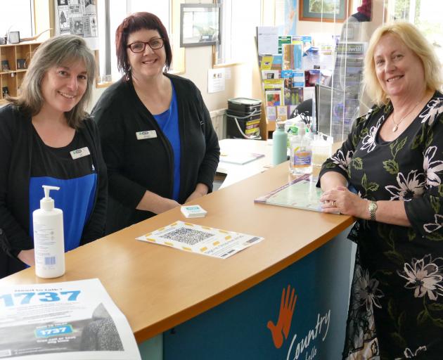 Clutha District Council library-service centre manager Debbie Duncan (right) checks in on...