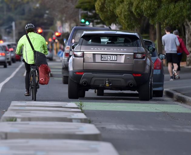 A cyclist is seen going around cars parked over the cycle lane on Great King St on Wednesday...