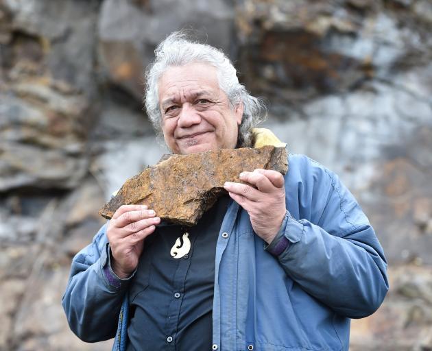 Harry Albert holds a piece of pillow lava found in the rock formations below First Church. He is...