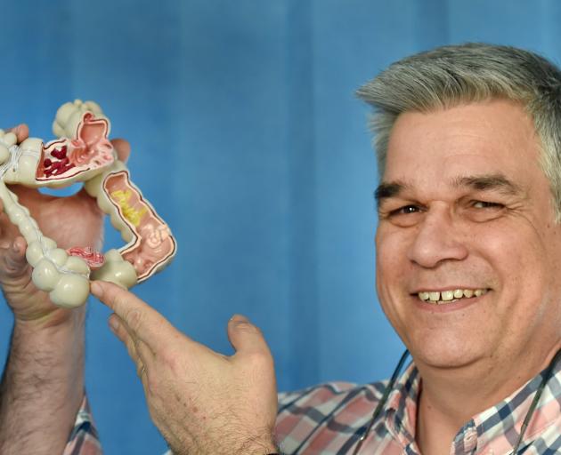 Gastroenterologist Prof Michael Schultz holds a model of a bowel. PHOTO: 
PETER MCINTOSH