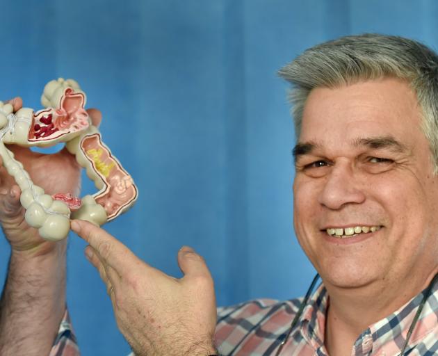 Gastroenterologist Prof Michael Schultz holds a model of a bowel. PHOTO:
PETER MCINTOSH