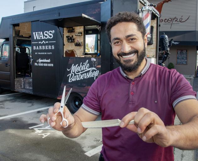 Wasseim Alsati outside his mobile barbershop on Victoria St. Photo: Geoff Sloan