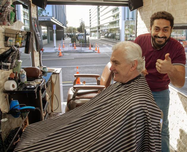 Wasseim Sati with regular customer Chris Goddard. Photo: Geoff Sloan