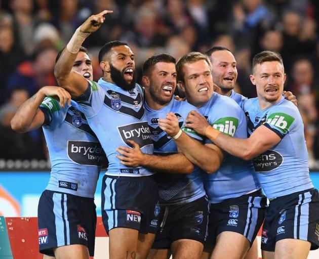 James Tedesco celebrates a try with New South Wales team mates during their win last night in the...