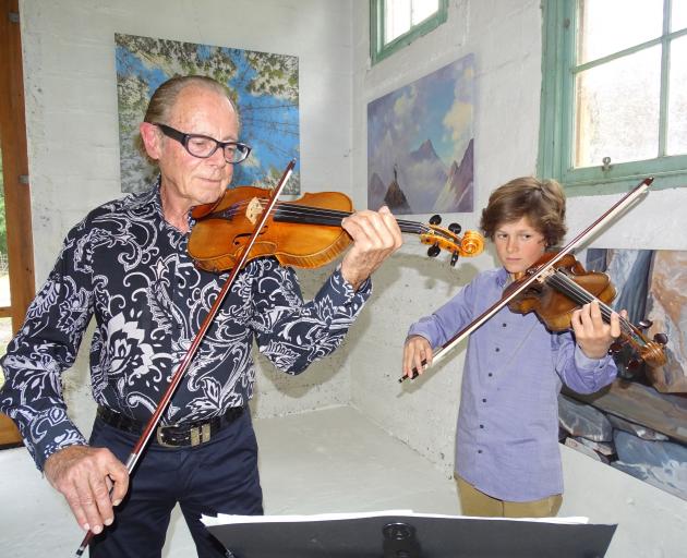 Michael Hill (81) plays the 1755 Guadagnini violin alongside grandson Jacob Jacques at the Thomas...