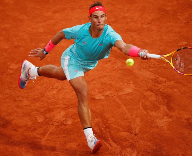 Rafael Nadal stretches to play a shot during his first round win at the French Open this morning....