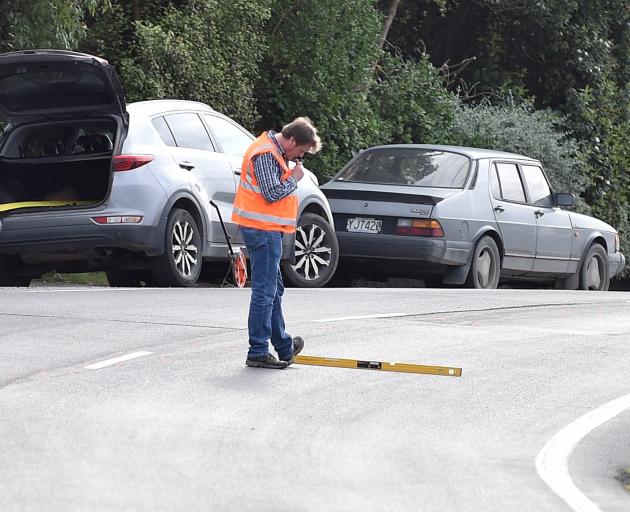 An investigator takes measurements at the scene of a fatal crash in Ravensbourne Rd, Dunedin,...