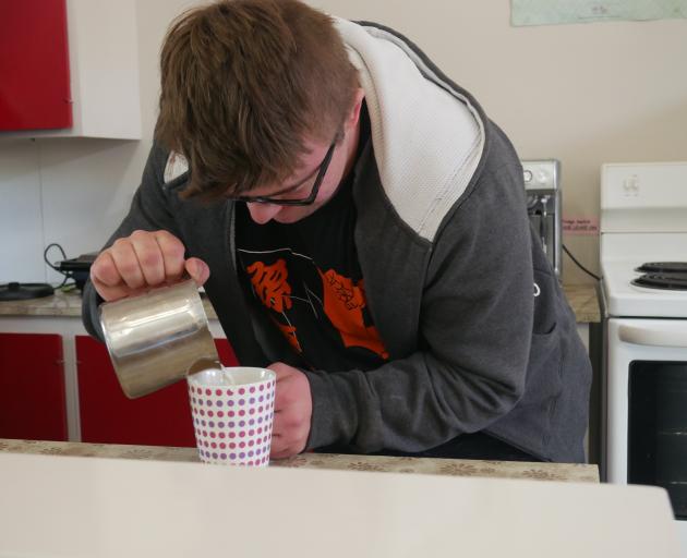 Sara Cohen School pupil Tayne McLaren (21) practises his barista skills on Monday. PHOTO: JESSICA...