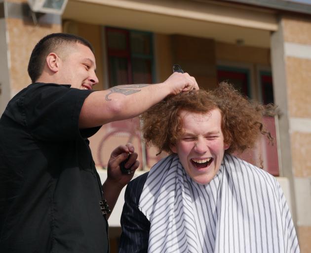 King's High School pupil Robbie Heller gets his hair shaved by Bloke barber Rewi Pomare at school...
