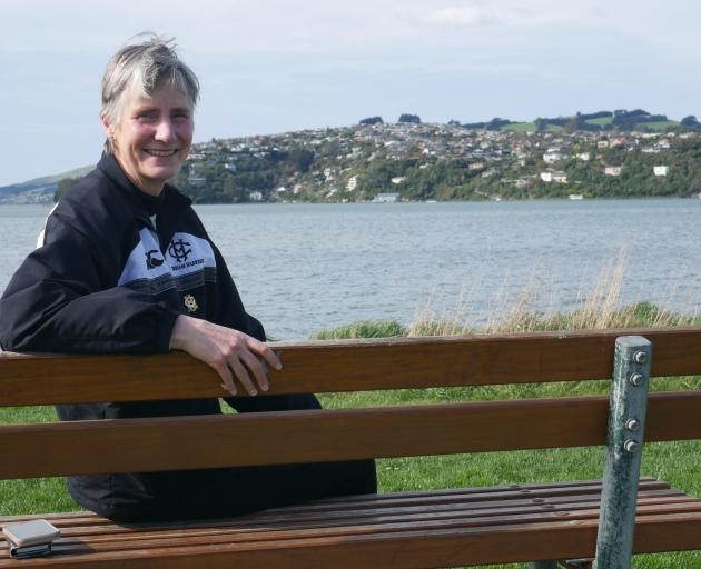 Dunedin Marathon organising committee chairwoman Maria Sleeman sits on the edge of Otago Harbour,...