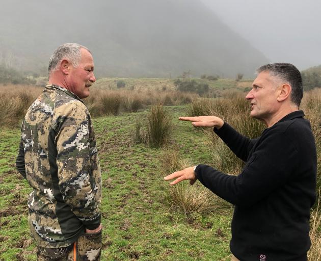 Prof Mark Stirling (right) talks to farmer Thomas Fischli about the Akatore Fault that crosses...