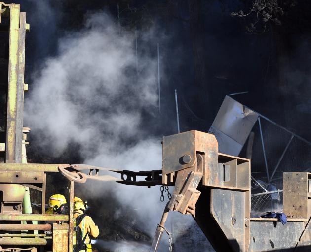 Fire and Emergency New Zealand firefighters work to put out a blaze that started at a commercial...