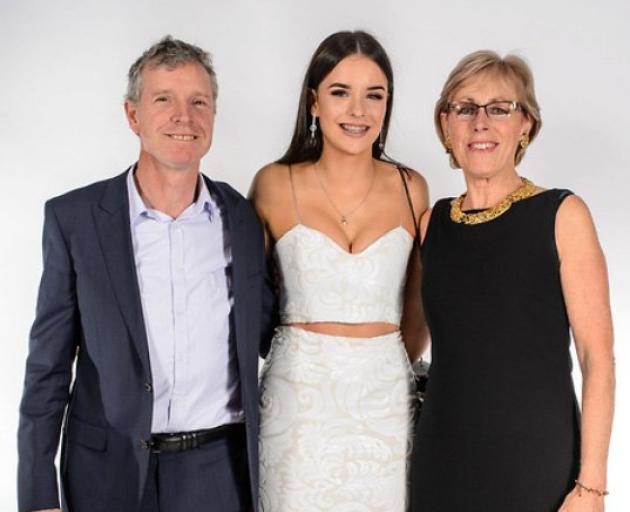 Sophia Crestani with her parents, Bede Crestani and Elspeth McMillan, ahead of her year 13 ball....