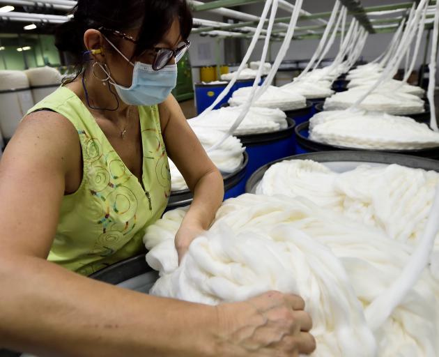 An employee works at Botto Giuseppe & Figli wool mill in Valdilana in northern Italy. Photo:...